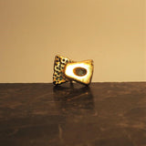 Bronze sculptural cufflink on a marble base